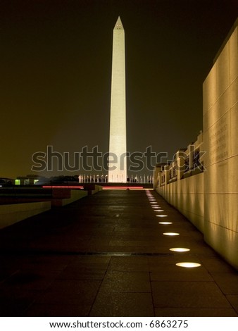 The World War II Memorial frames The Washington Monument at night in the nations capital.