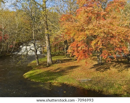 Brilliant Autumn colors frame this stream and waterfalls in the Pocono Mountains of Pennsylvania.