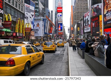 NEW YORK - FEB 27: Taxis move past people in Times Square on February 27, 2009 in New York City. New Plans to ban vehicle traffic on Broadway from 42nd to 47th Streets are scheduled to begin this May.