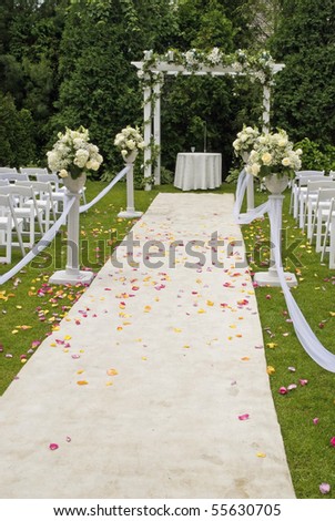 stock photo A white wedding carpet covered in rose petals and the scene of 
