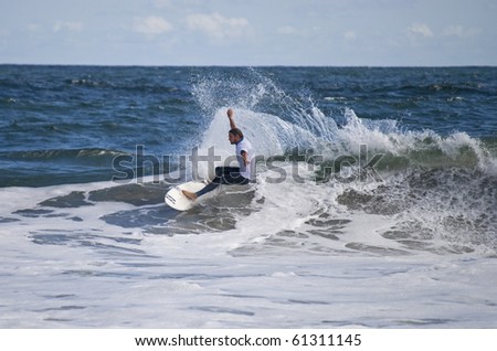 BELMAR, NJ - SEPTEMBER 18: Unidentified surfer catches a wave at The Foster\'s Belmar Pro Surfing contest on Sept. 18, 2010 in Belmar, NJ