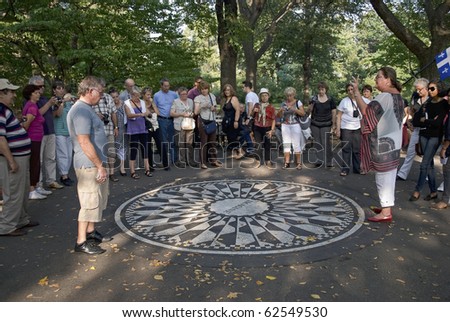 MANHATTAN - OCTOBER 7: Tourists visit Strawberry Fields at Central Park to commemorate John Lennon\'s 70th Birthday on October 9th, 2010 in Manhattan