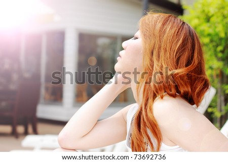 beautiful lady is closing her eyes on the sun shine day