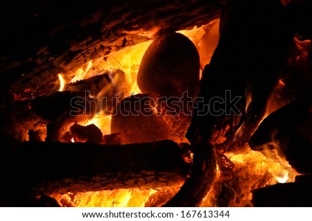 A large ceremonial fire made with oak logs is used to heat river stones for sweat lodge.