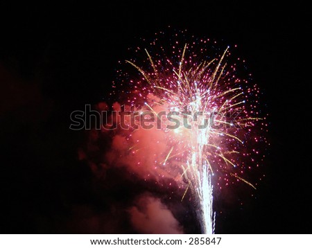 colorful firework shooting upward into the night sky, fourth of july celebration, easthampton, massachusetts