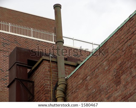 Boston Roof Top with smoke stack, showing brick walls, railings, and duct work