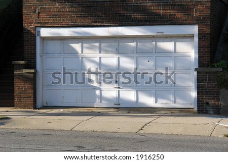 old garage door in need of a fresh coat of white paint