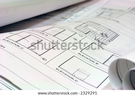 close up of blue prints laid out on desk