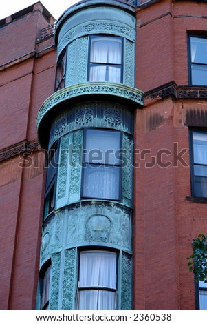 ornate rounded bay windows on old brownstone apartment house in boston\'s back bay