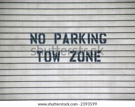garage door sign no parking tow zone, black on gray with slats