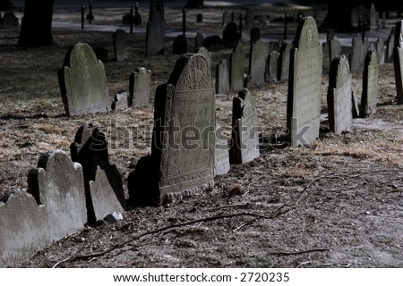 spooky looking moss covered tomb stones on a beautiful winter's afternoon
