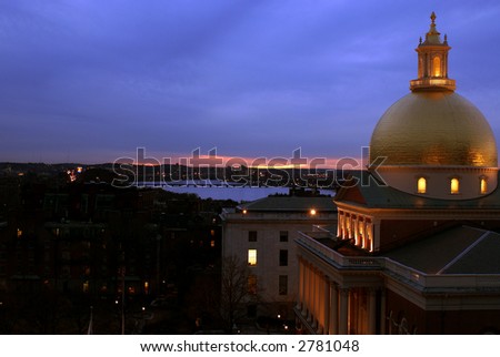 Late winter sunset over the charles river with  purple and pink tones in the sky, in the fore is the massachusetts state house