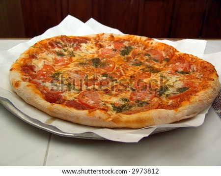fresh baked pizza pie on platter cut into squares
