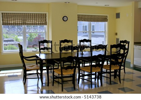 old fashioned dining table in yellow room with windows over looking garden