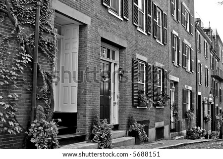 Famous Acorn Street, america\'s most photographed area in the Beacon Hill area of Boston Massachusetts, showing gas light, cobblestone road, shutters.