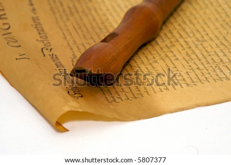 woodwind instrument, the recorder laying on old parchment document, copy of declaration of independence