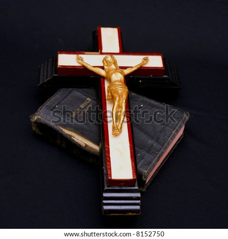 full color image of an old crucifix laying on top of an ancient leatherbound bible