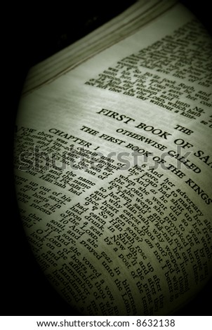 bible series, detail of an old antique holy bible against a black background open to the first book of samuel otherwise called the first book of the kings finished in sepia