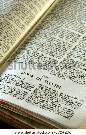 Bible Series. close up detail of antique holy bible open to the book of daniel in the old testament