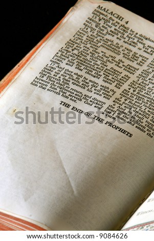 Bible Series. close up detail of antique holy bible open to the book of Malachi in the old testament, the end of the prophets