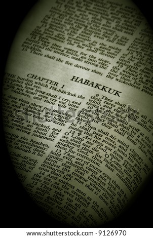 Bible Series. close up detail of antique holy bible open to the book of Habakkuk in the old testament finished in sepia