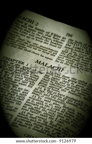 Bible Series. close up detail of antique holy bible open to the book of Malachi in the old testament finished in sepia