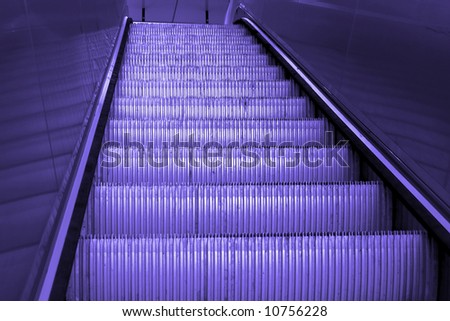 going up a shiny metal staircase, escalator, empty, finished with blue tine