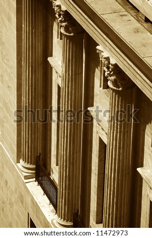 looking down on marble columns on old building with metal railing