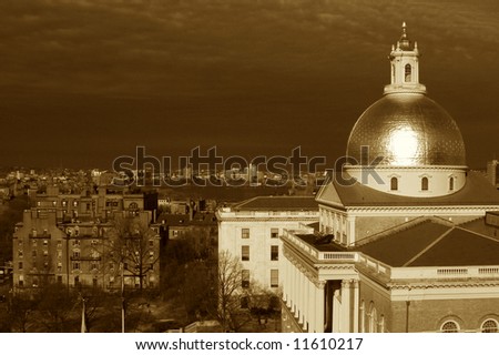 clouds battle the sunshine as the golden dome of the massachusetts state house glows in this dramatic sepia toned image