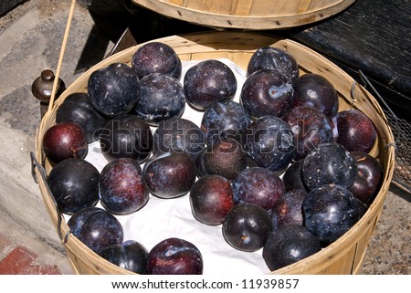 basket full of plums at fruit stand