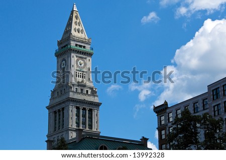 the clock on the custom house tower in boston Massachusetts reads ten before two on a partly cloudy day