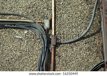 electrical conduits and wires on gravel roof top