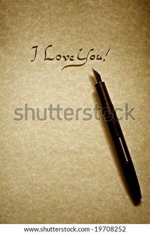 i love you letter being written in calligraphy on parchment paper with pen finished in sepia