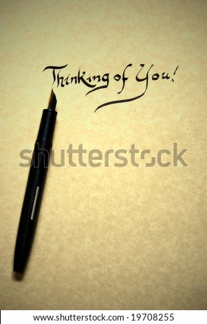 thinking of you letter being written in calligraphy on parchment paper with pen