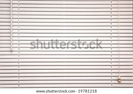 background image of off white mini blinds inside home closed
