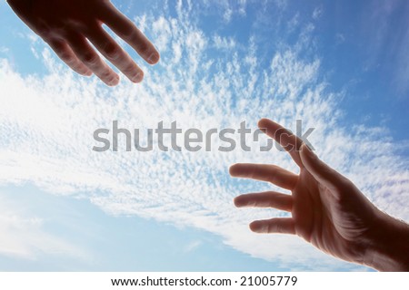 two male hands with fingers outstretched reaching out toward each other