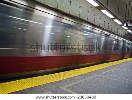 red line train on the boston mbta in motion pulling out of the subway station