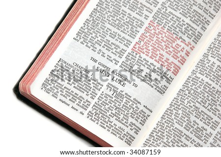 holy bible open to the gospel according to saint luke, against a white background