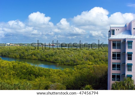 looking down at the canals, trees and buildings in bonita springs florida