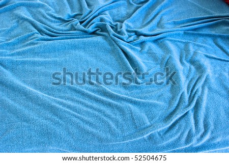 background image of  rumpled old blue blanket covered with soft folds