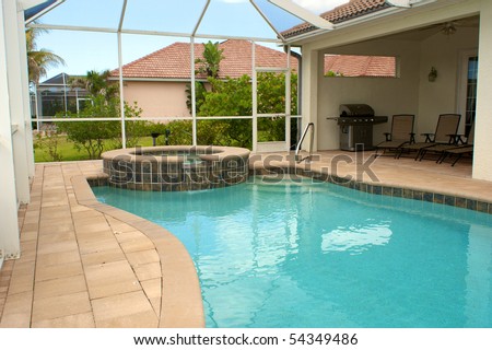 view of screened in pool and lanai or patio in florida with blue sky and sitting area