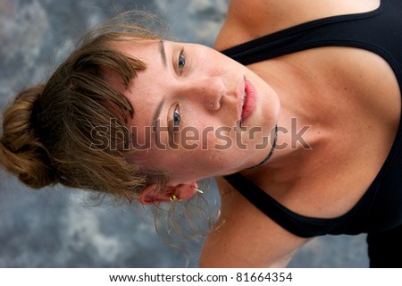Close up image of a woman\'s face as she exercises and her head is sideways.