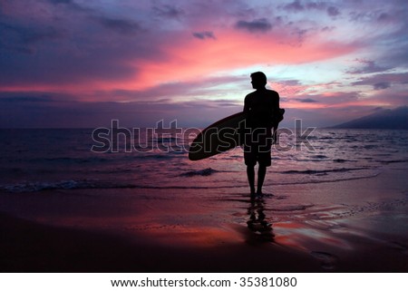 man with surfboard at sunset on tropical beach