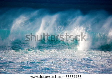 massive crashing wave rolling across the ocean