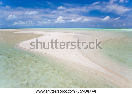 beautiful sand island in turquoise waters in tahiti
