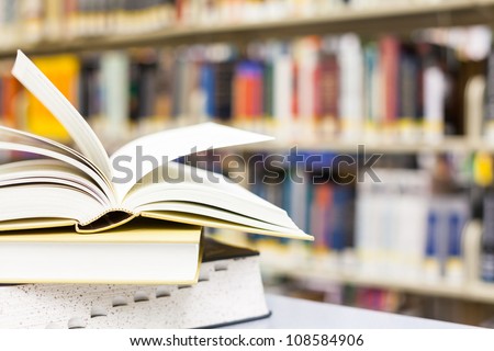 library setting with books and reading material (Please note that many books with legible titles are filler titles that only state the \'type\' of materials contained within and date)