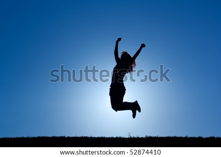 silouhette of a female in the sun jumping in victory
