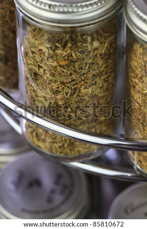a spice rack close up, filled with fresh organic spices and herbs