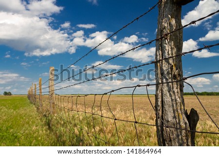 Kansas pastureland; fence with barbed wire