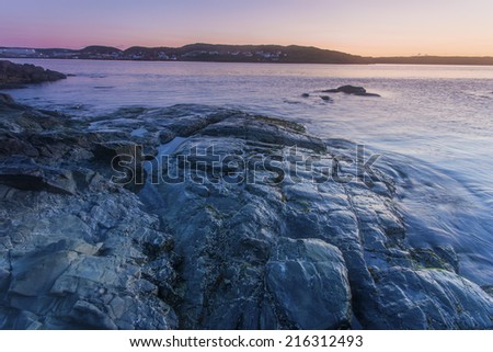 light from early dawn on coastal rocks at St. Anthony, Newfoundland, Canada